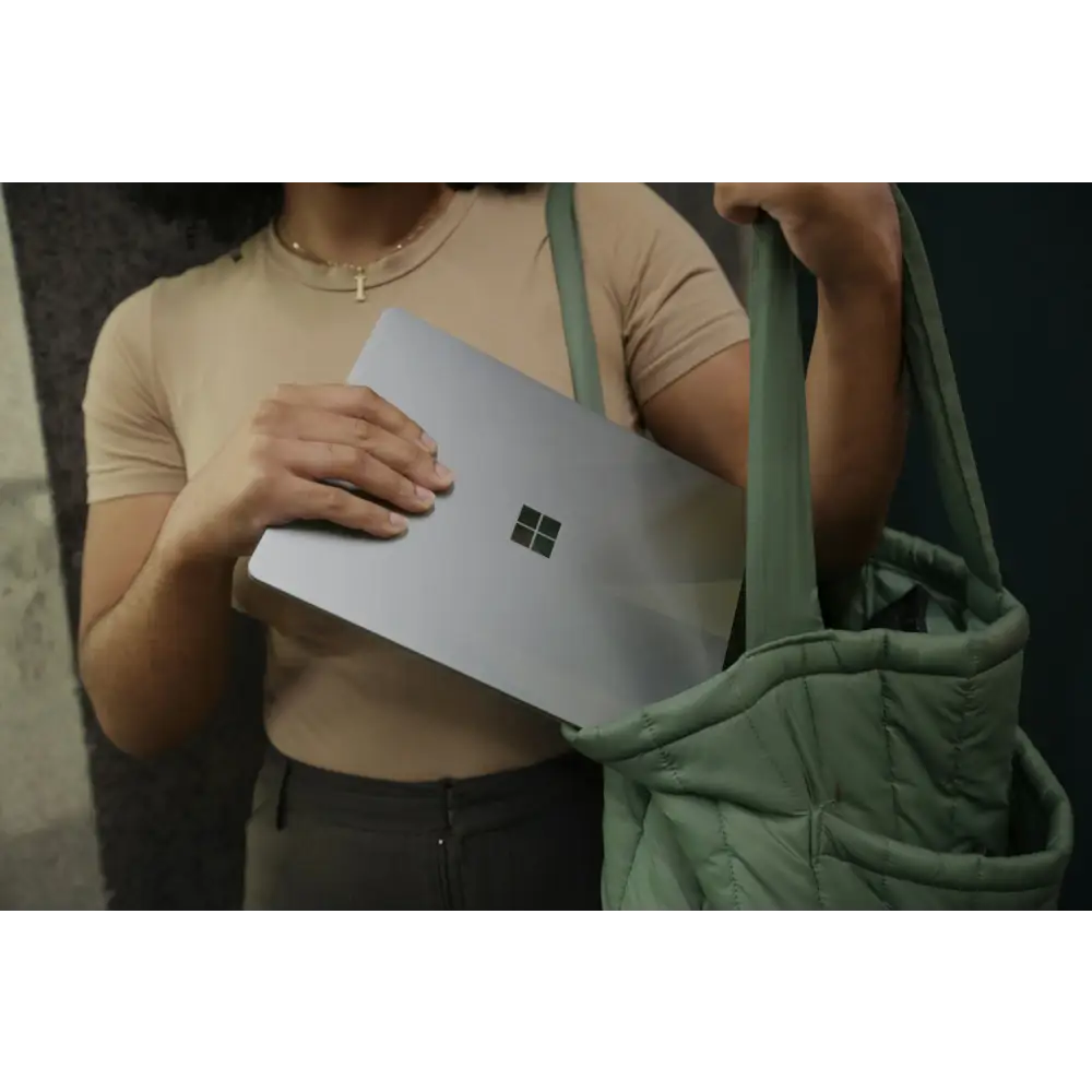 Female putting her Surface laptop in her bag